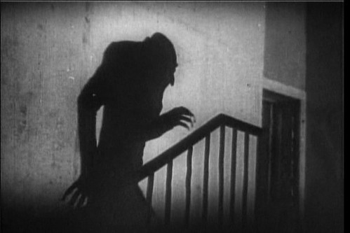 A shadowy figure creeping up the stairs.